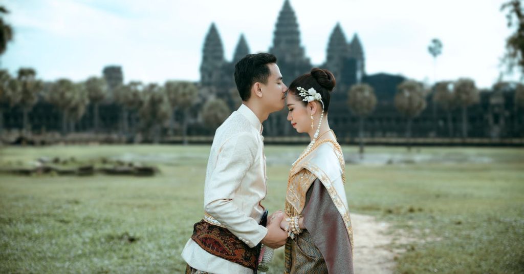 a-couple-in-traditional-clothing-standing-in-front-of-a-temple