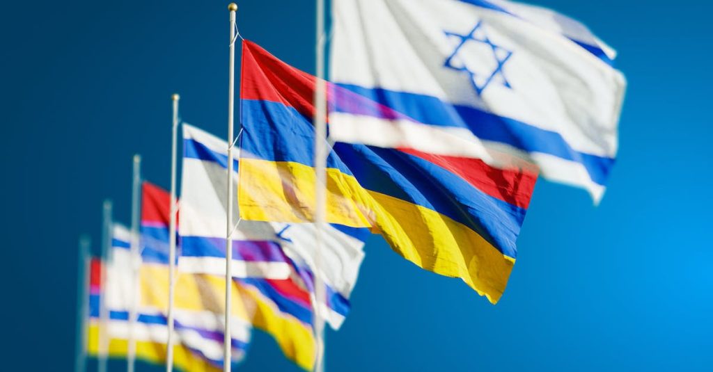 armenia-and-israel-flags-against-blue-sky