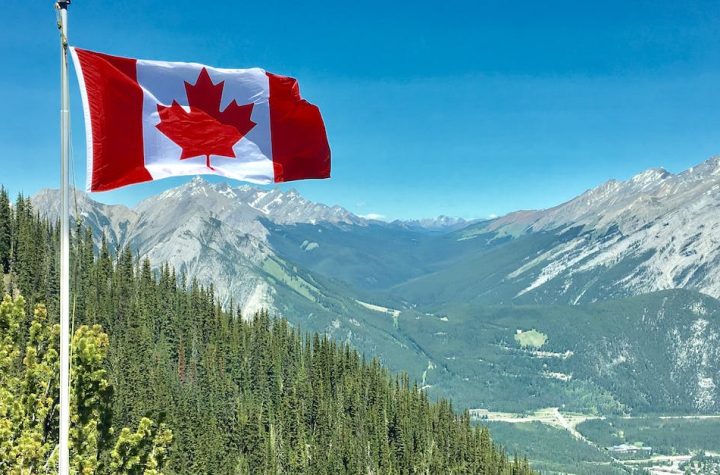 canada-flag-with-mountain-range-view