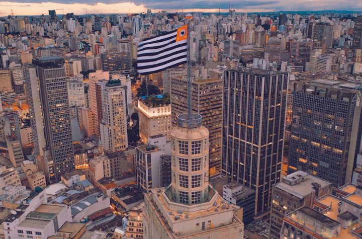 cityscape-of-contemporary-megapolis-with-flag-in-city-center-and-skyscrapers-located-around