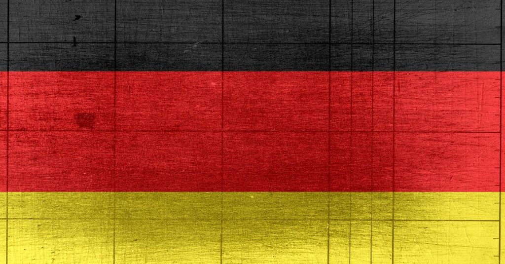 grungy-background-designed-as-flag-of-germany-on-shabby-wooden-board-with-measure-scale