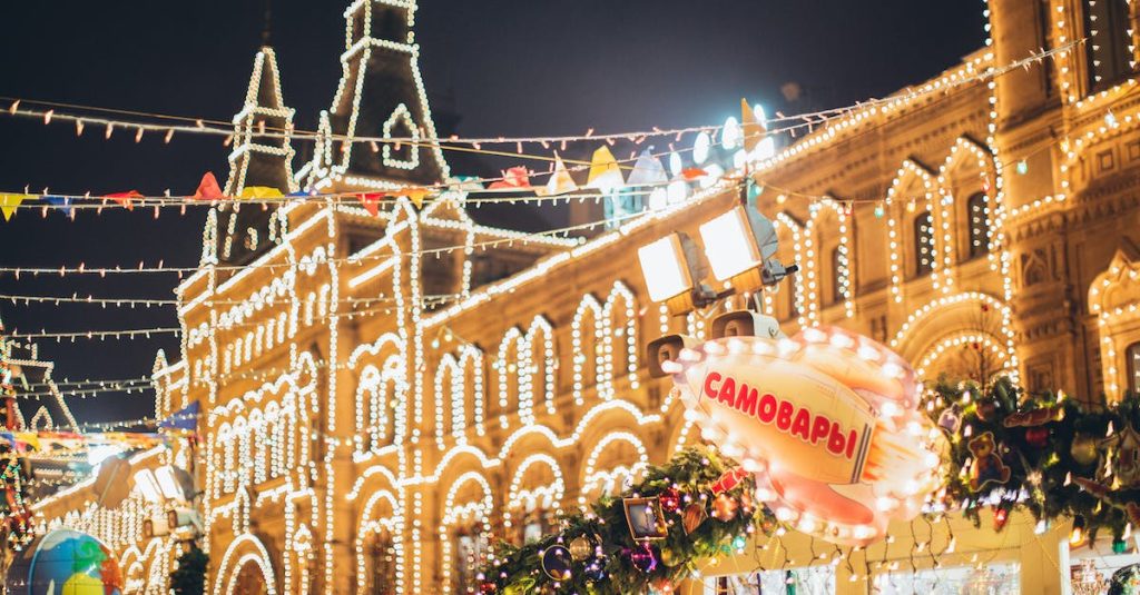 low-angle-of-exterior-of-old-building-decorated-with-small-round-white-lamps-during-christmas-holida