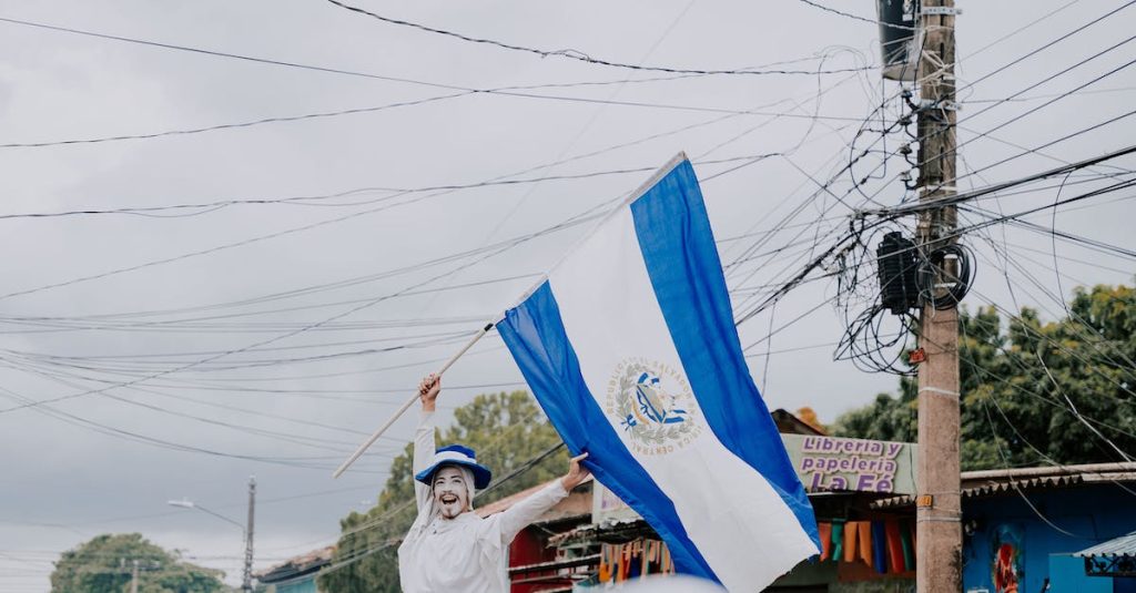 man-waving-an-el-salvadoran-flag-on-the-street