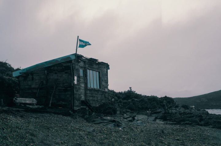 wooden-house-with-a-flag-of-argentina-near-the-sea